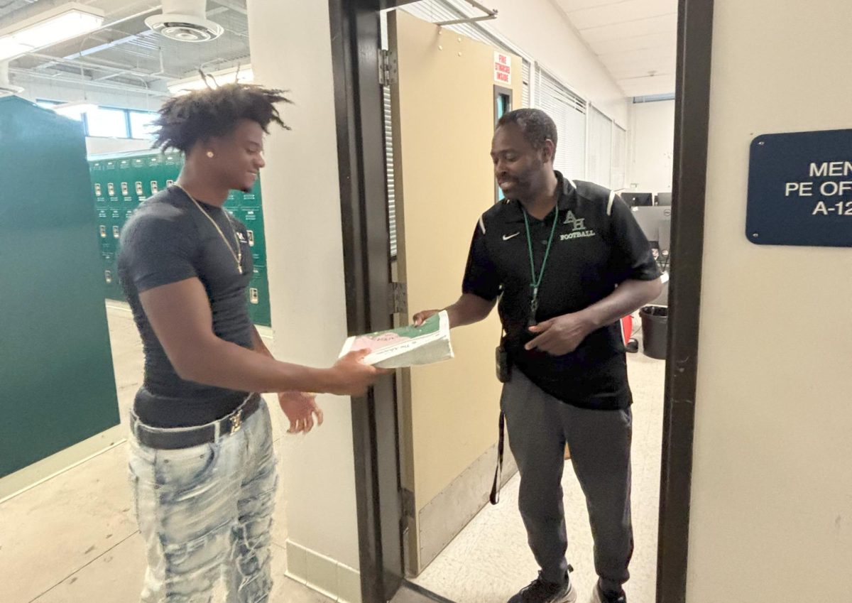 This is me, Jamarieah Wallace delivering my last paper to Coach Coltress, the Athletic Director for Hawkins High school.photo credit Coach Darrell Brown