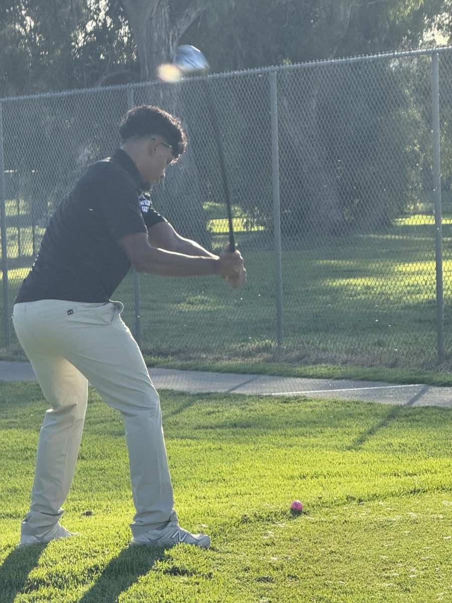Getting ready for that big swing to the golf ball! Look at him go!